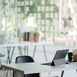 Contemporary workplace with modern tablet and office supplies.