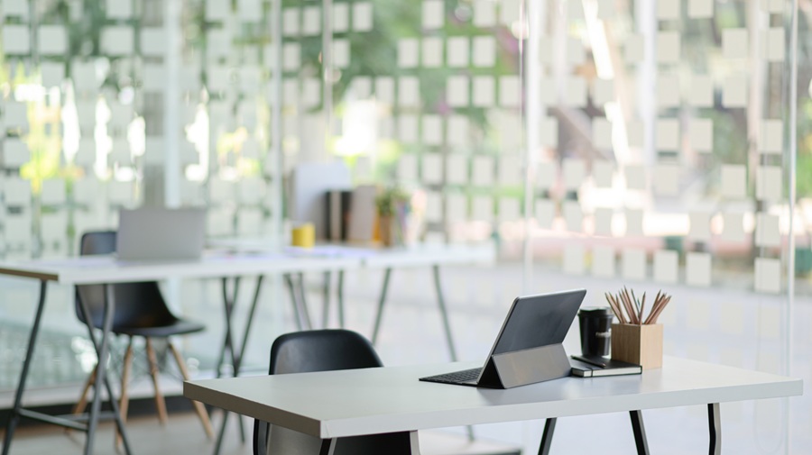 Contemporary workplace with modern tablet and office supplies.